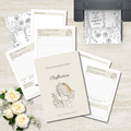 A styled flat-lay of a journaling set on a light wood surface, including a central cream-colored journal titled 'The Bloom Journal Series - Reflection' with an illustration of a girl reading, several lined daily log pages, floral printed inserts, and a black printer showing a matching printout. White roses are placed in the lower left corner.