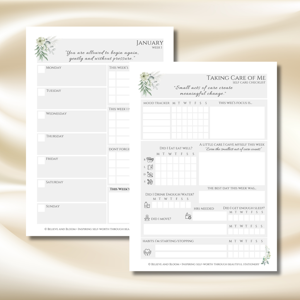Two printable self-care journaling sheets from Blush and Bloom Threading, displayed on a soft beige satin background. The sheets feature elegant watercolor greenery and floral designs, with one sheet titled 'January Week 1' and the other titled 'Taking Care of Me' with reflection prompts and tracking boxes.