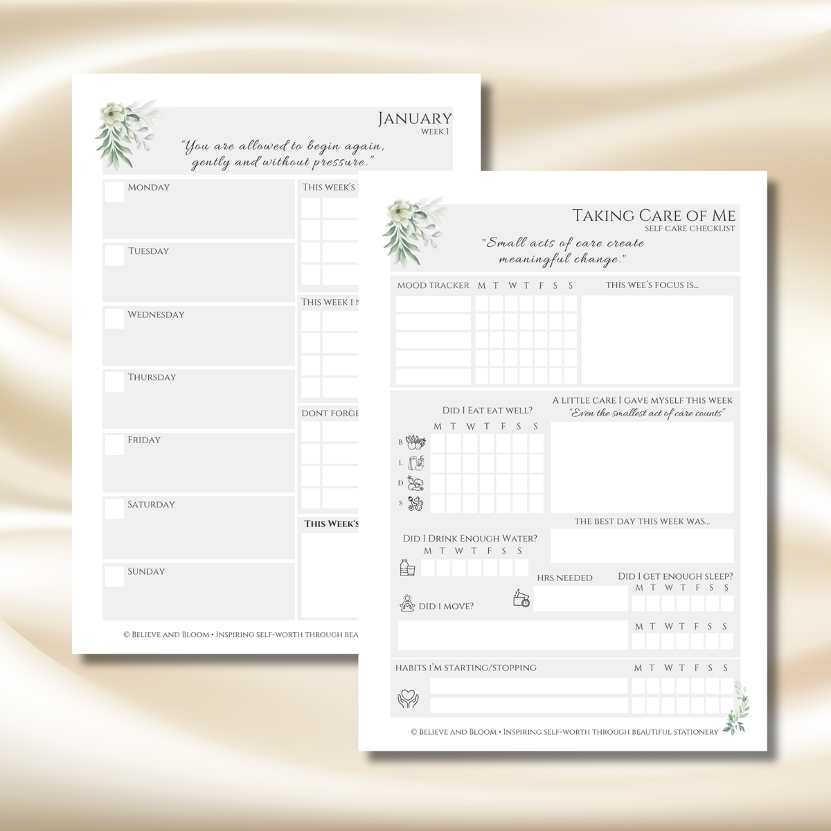 Two printable self-care journaling sheets from Blush and Bloom Threading, displayed on a soft beige satin background. The sheets feature elegant watercolor greenery and floral designs, with one sheet titled 'January Week 1' and the other titled 'Taking Care of Me' with reflection prompts and tracking boxes.