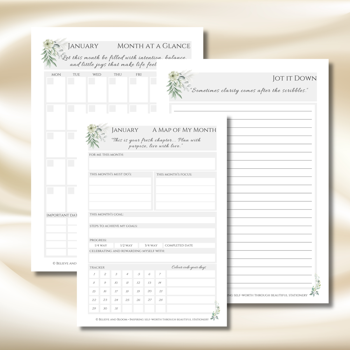 Two printable January planner pages with watercolor greenery accents, shown overlapping on a soft cream background. One page is titled 'January Month at a Glance' and the other 'January A Map of My Month' with writing areas and a calendar grid.