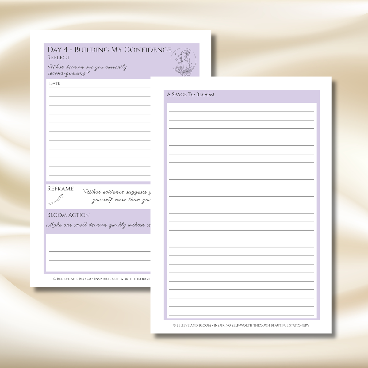 Two white notepad sheets with lavender purple headers and lined writing areas, displayed on a soft beige satin fabric background. One sheet shows reflective prompts and the other shows lined space for writing.